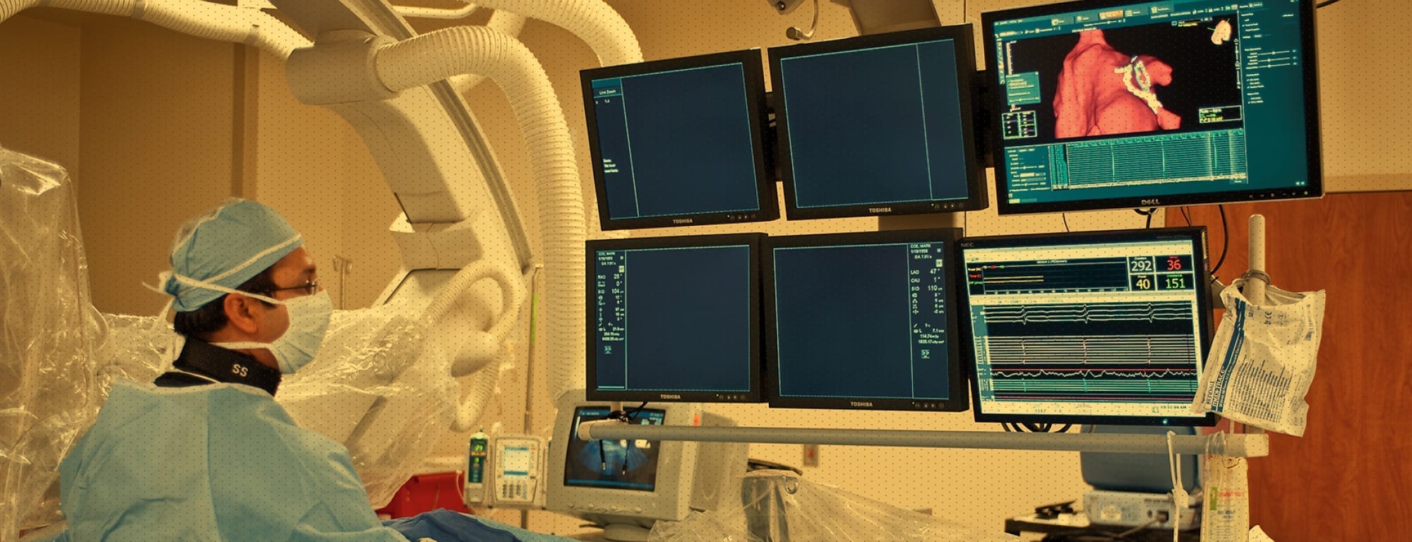 Surgeon in scrubs looking at screens during procedure